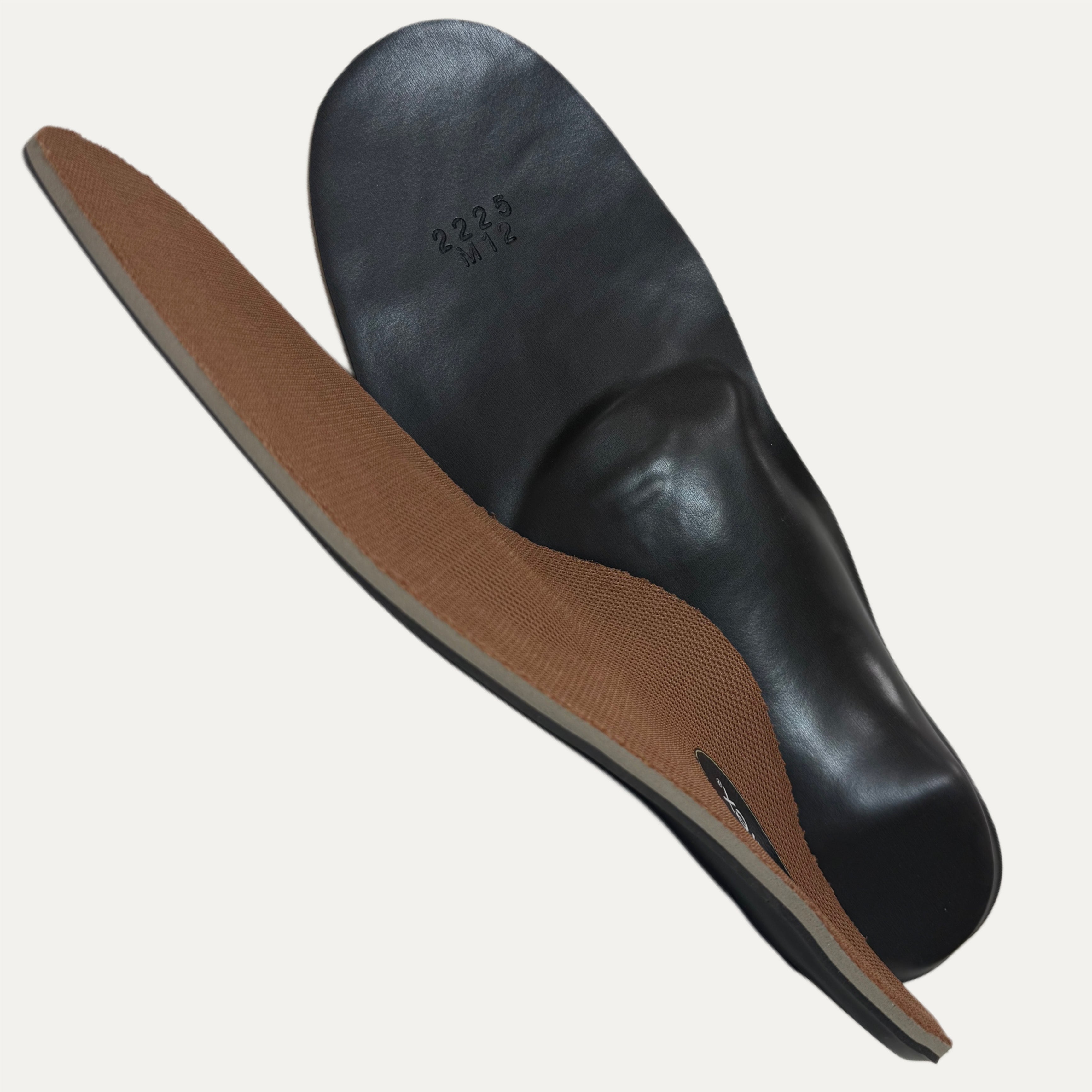 Black and brown shoe insole on a white background