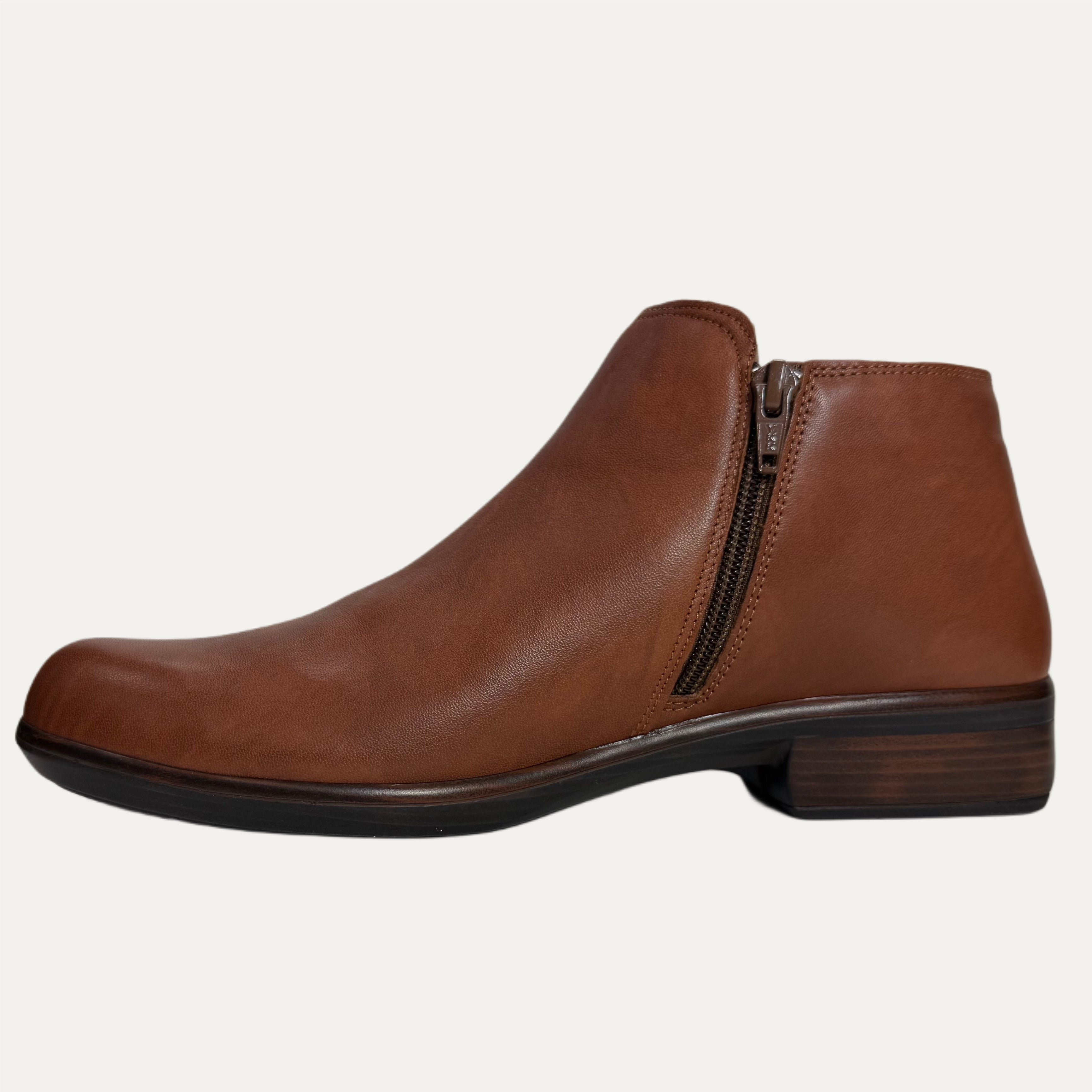 Brown leather ankle boot with a zipper on a white background