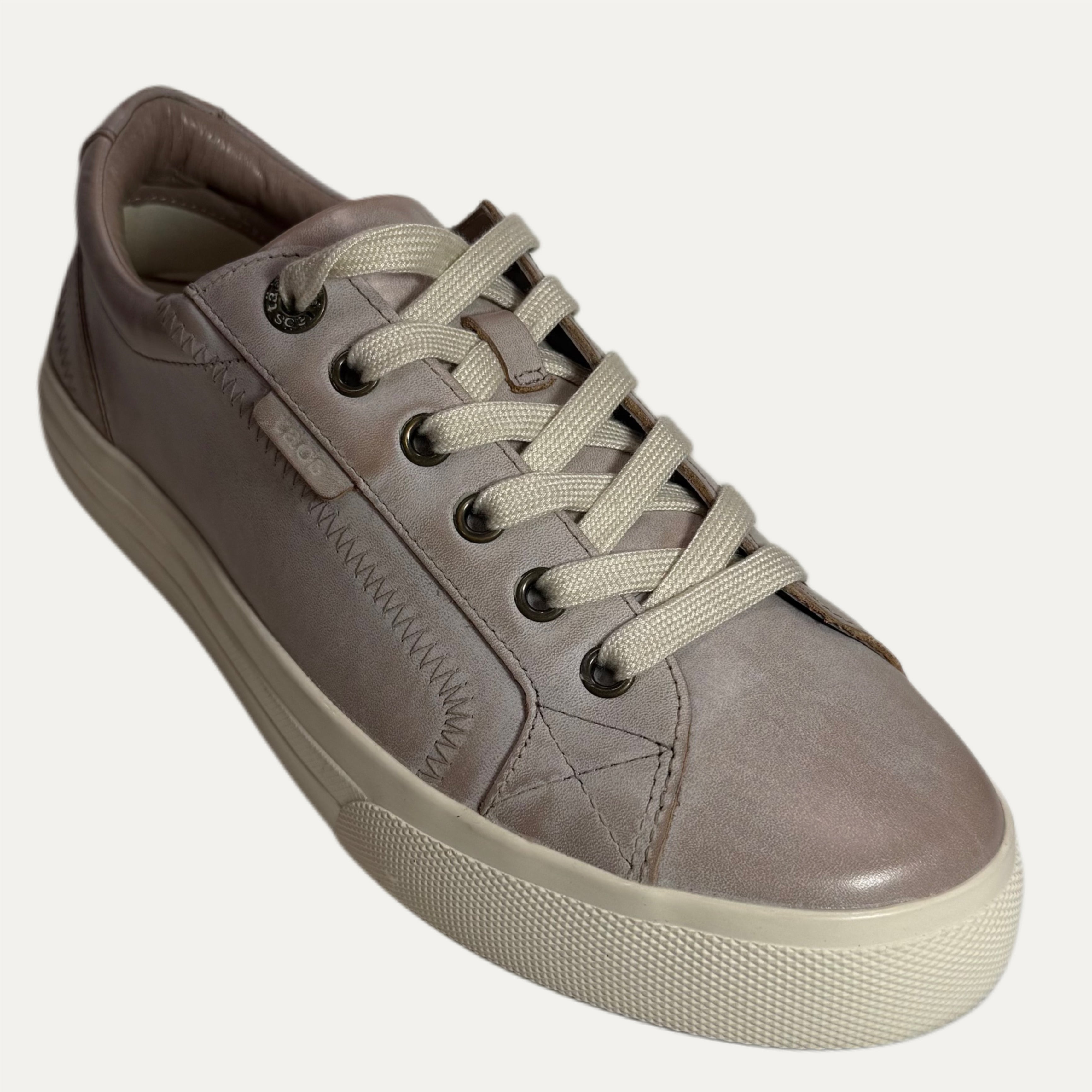 Beige sneaker with white laces on a white background