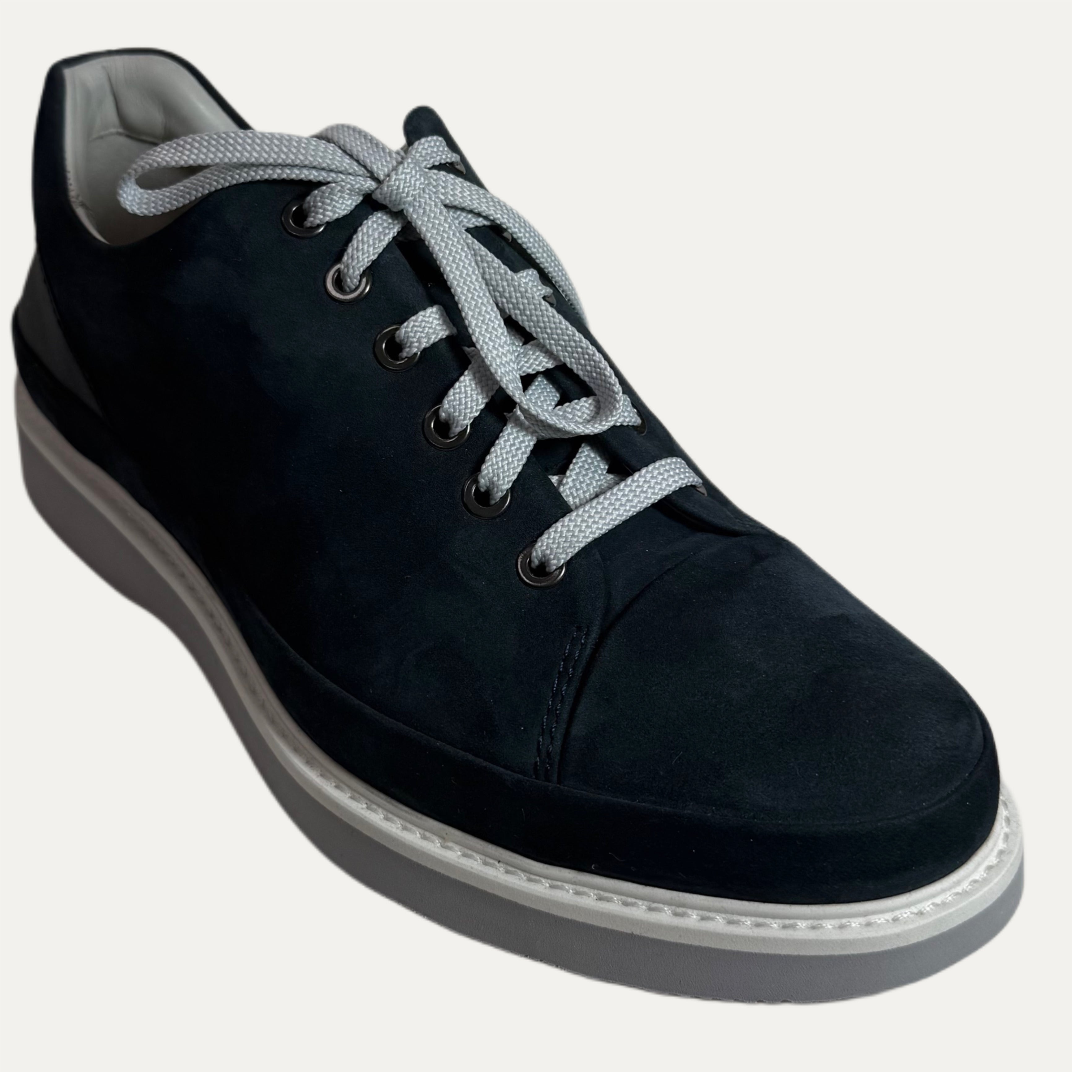 Black casual shoe with gray laces on a white background