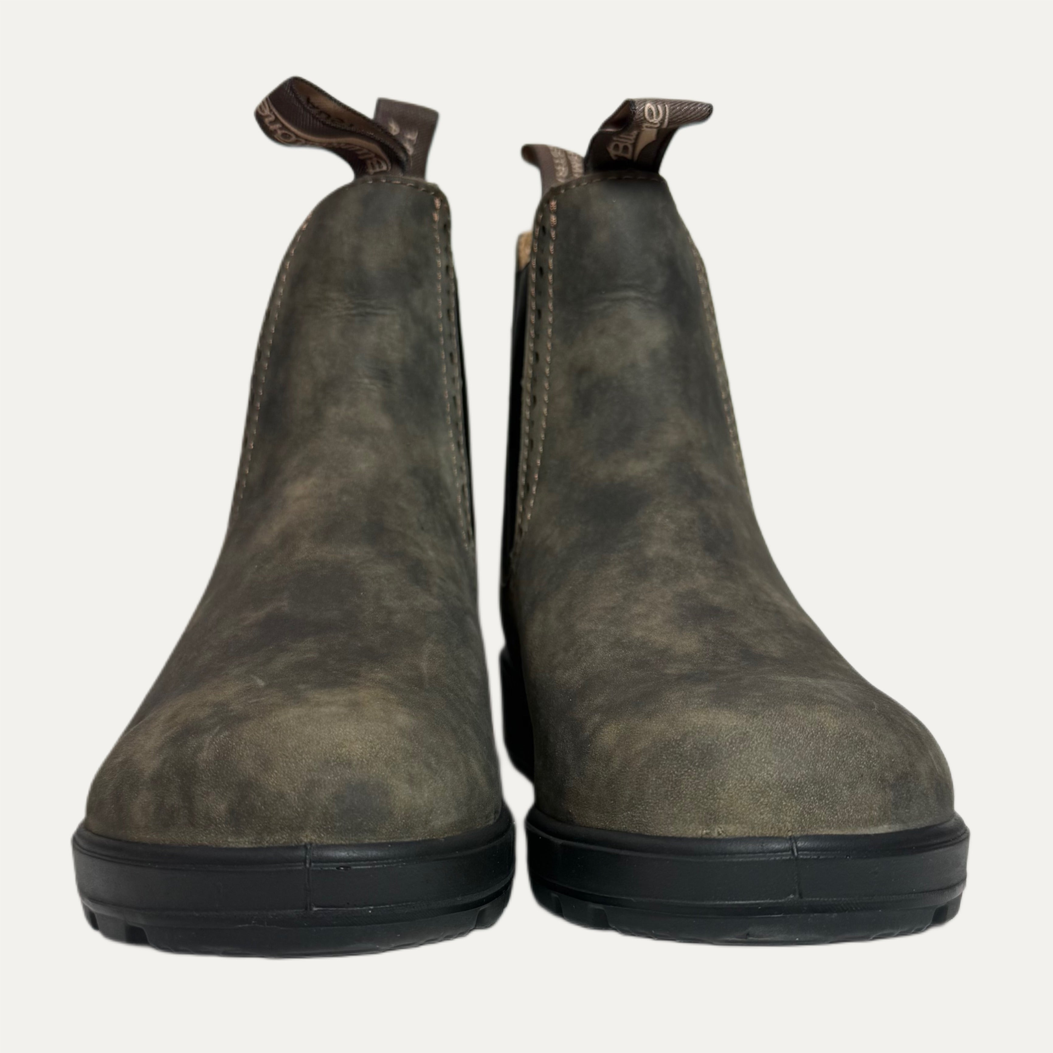 Pair of brown leather boots on a white background