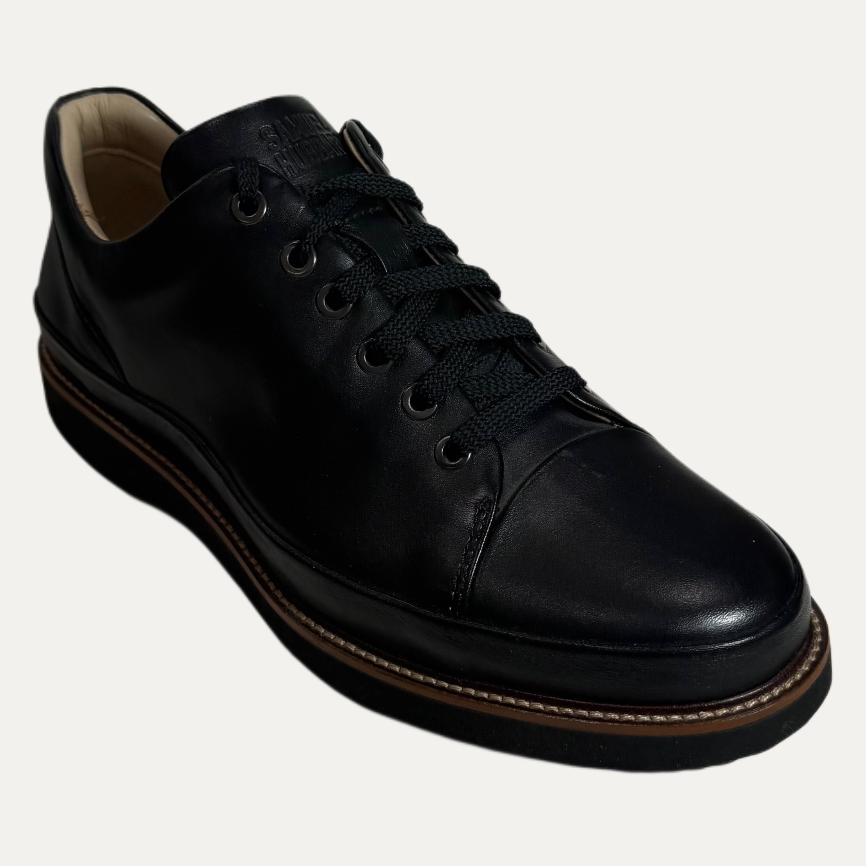 Black leather shoe on a white background