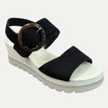 Black sandal with a brown buckle on a white background