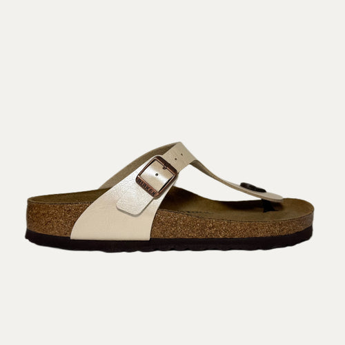 Beige sandal with a brown sole on a white background