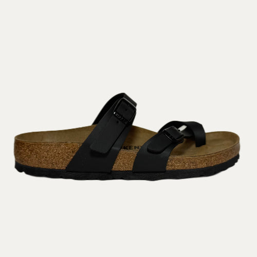 Black sandal with cork sole on a light gray background