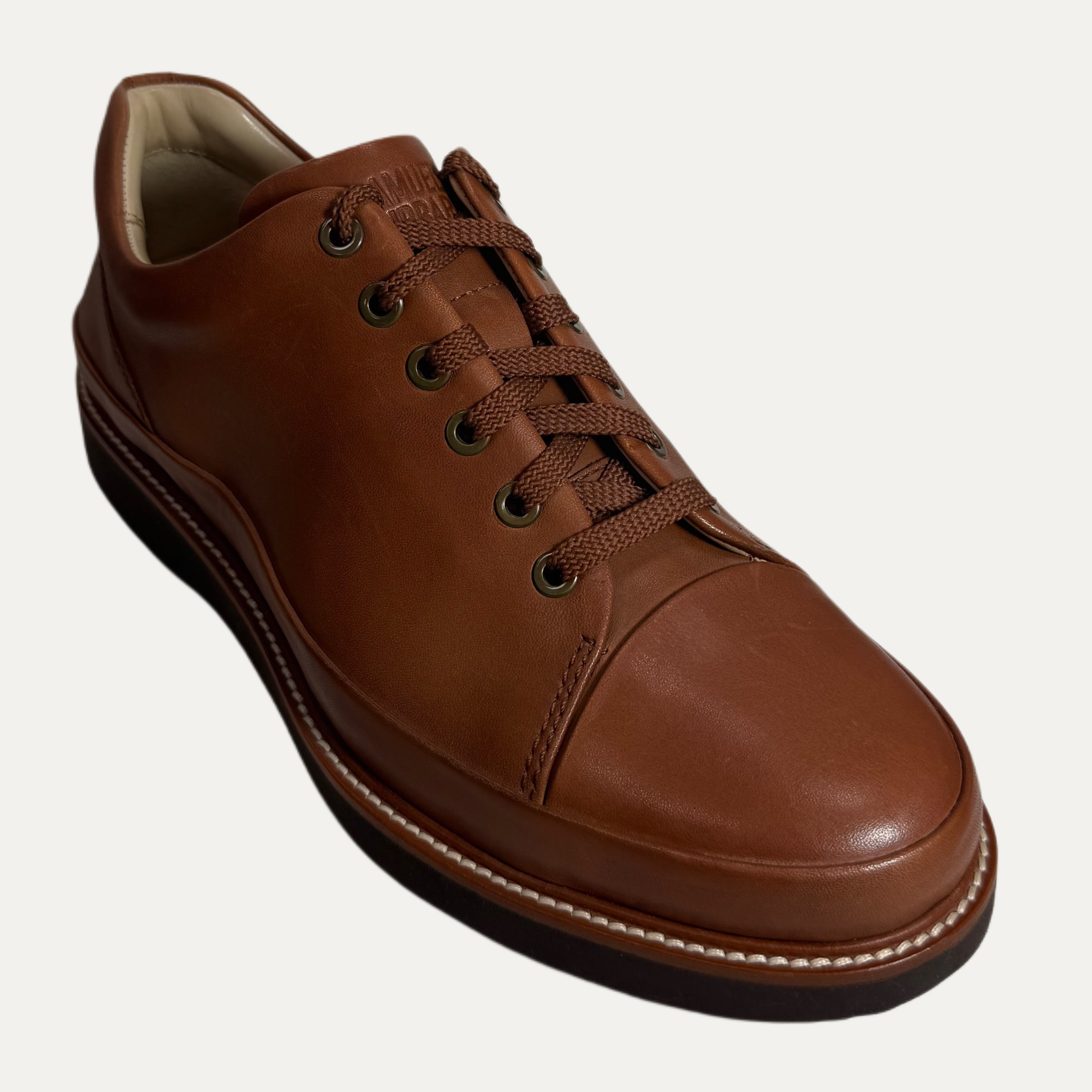 Brown leather casual shoe on a white background