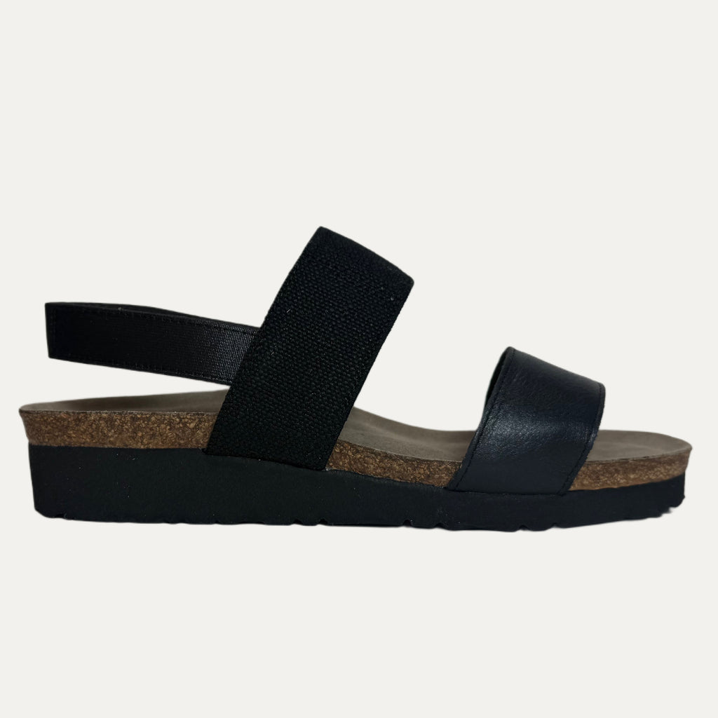 Black sandals with cork sole on a light gray background