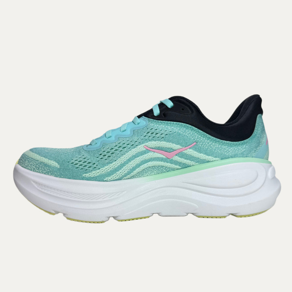 mint green running shoe with pink accents on a white background