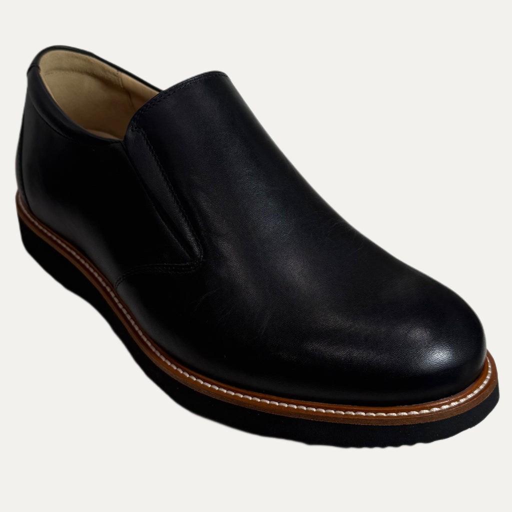Black leather slip-on shoe on a white background
