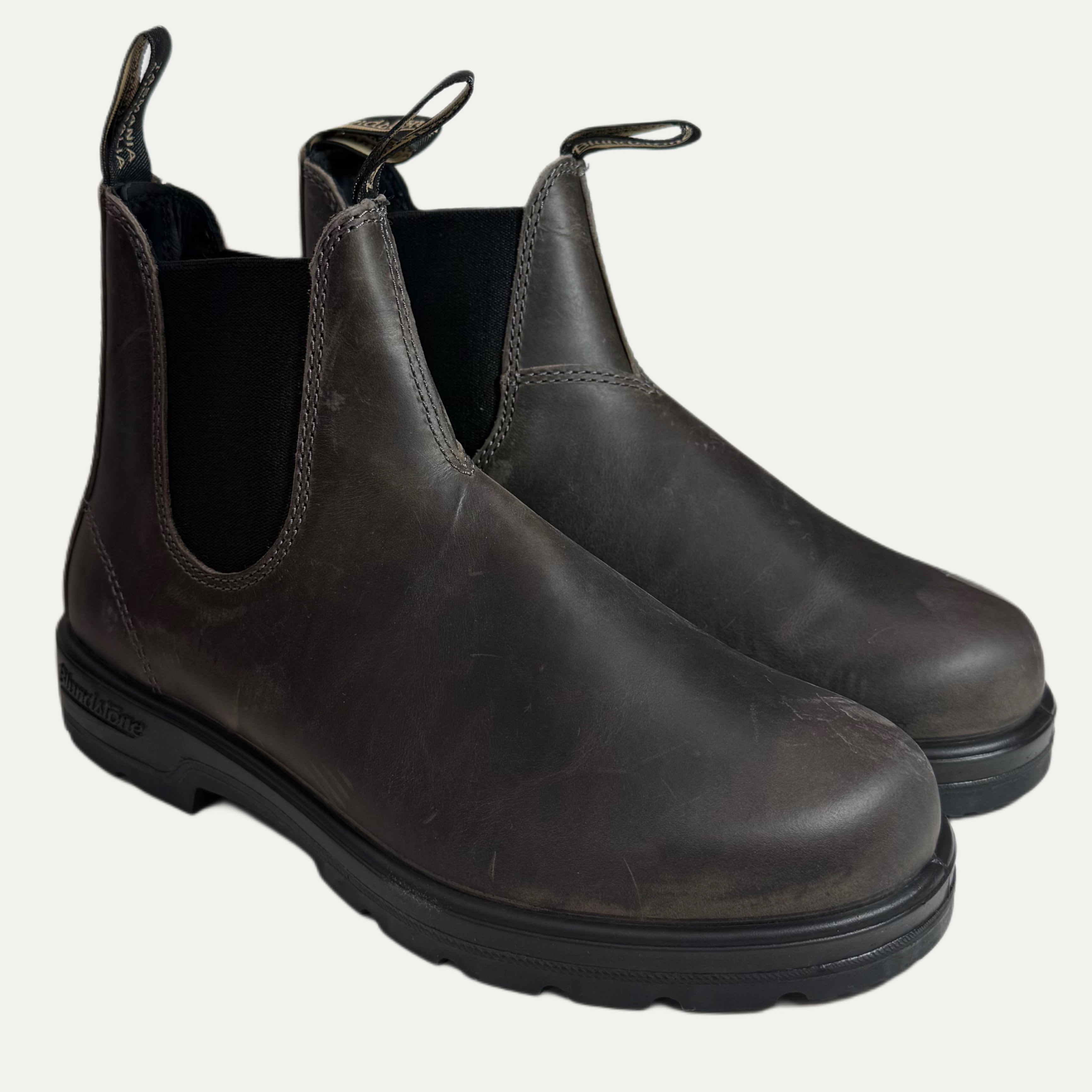 Pair of brown grey leather Chelsea boots on a white background