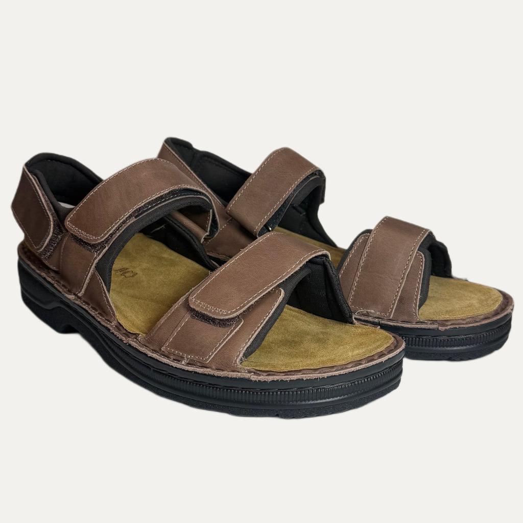 Brown sandals with velcro straps on a white background