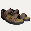 Brown sandals with velcro straps on a white background