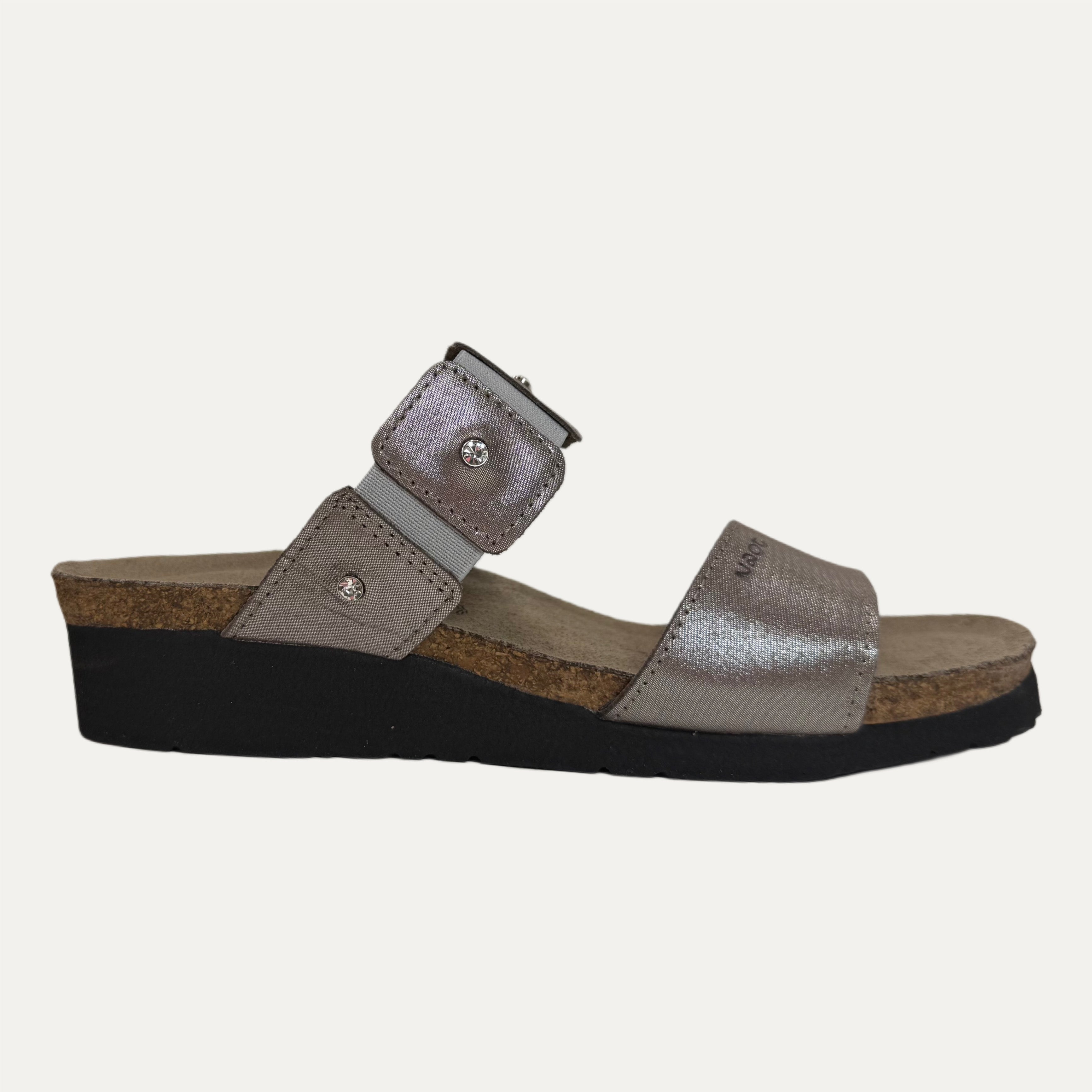 Silver sandal with a black sole on a white background