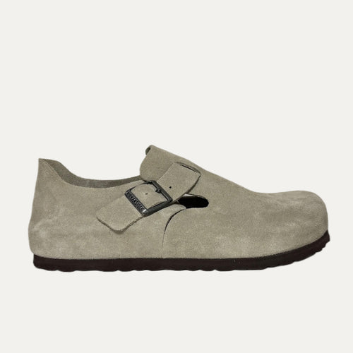 Beige shoe with a buckle on a white background