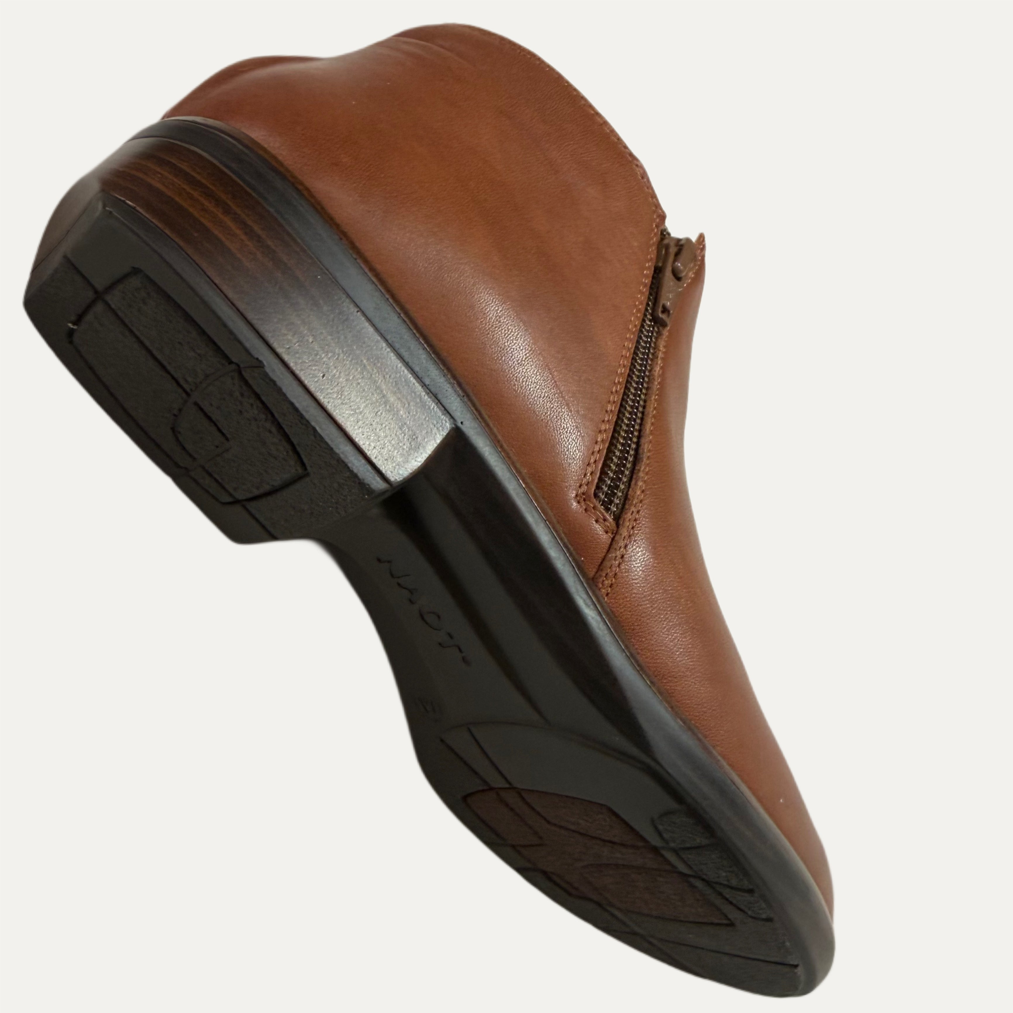 Brown leather shoe with a black sole on a white background