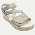 Silver glitter sandal with a white sole on a light beige background