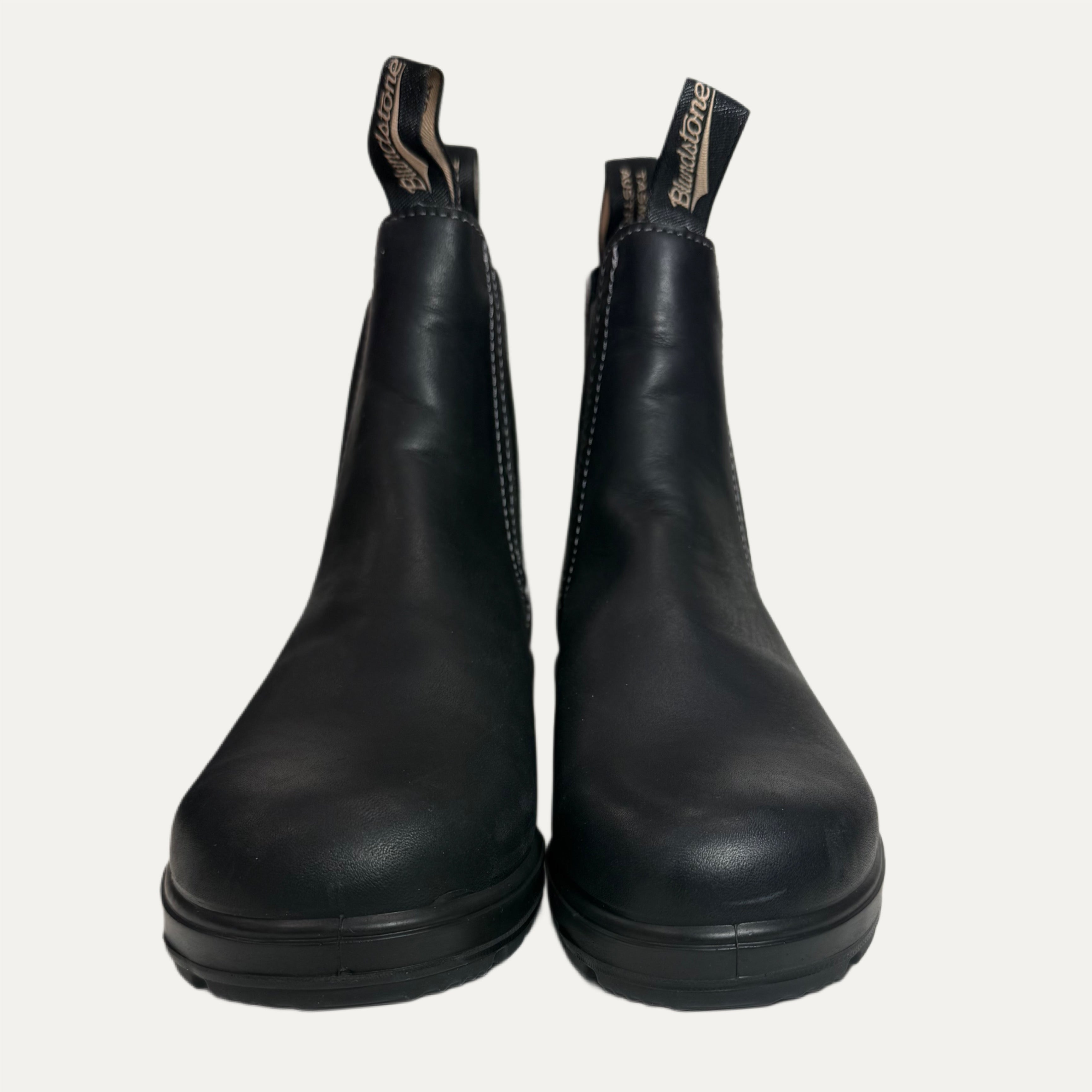 Pair of black leather boots on a white background