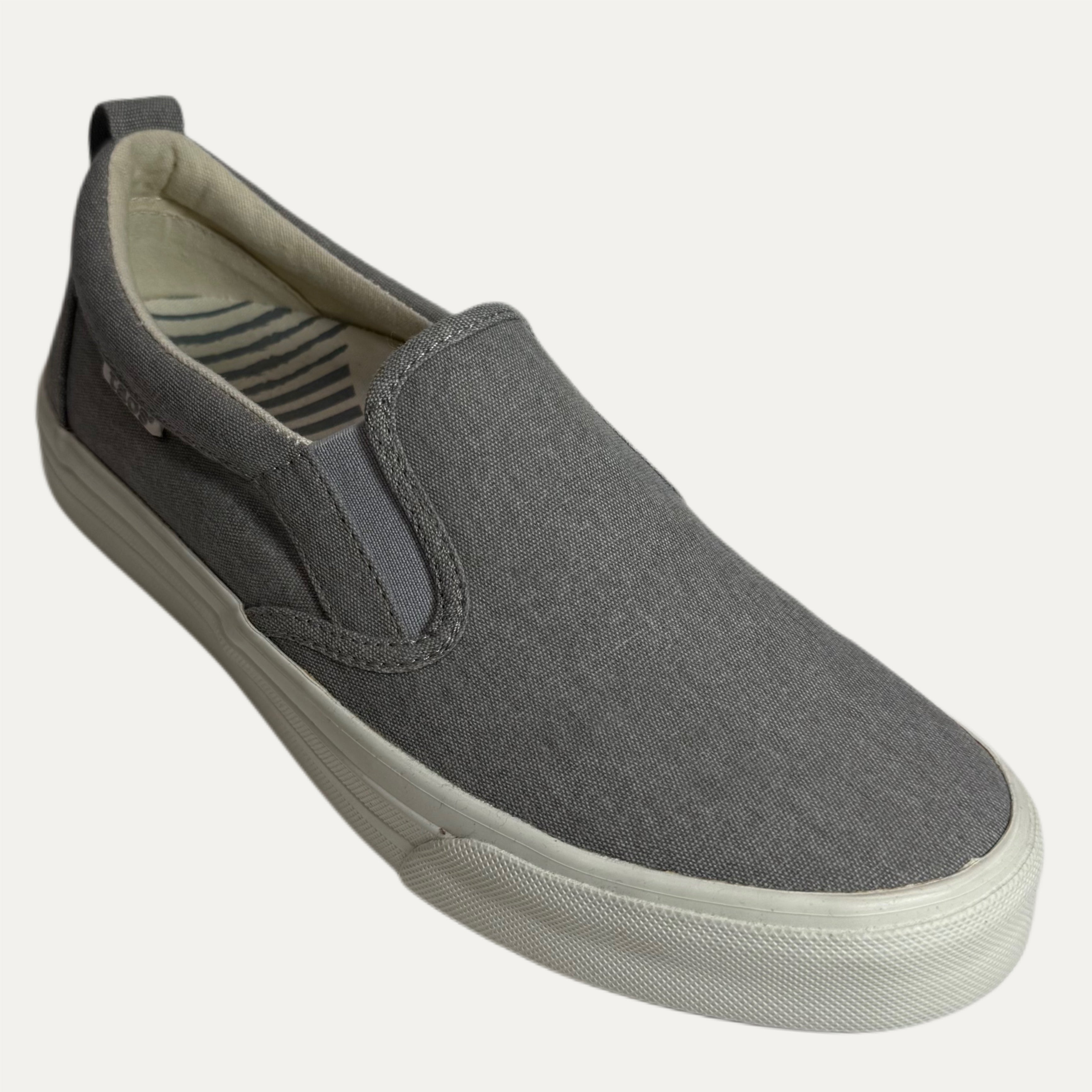 Gray slip-on sneaker with a white sole on a white background