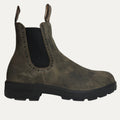 Brown Chelsea boot with black sole on a white background