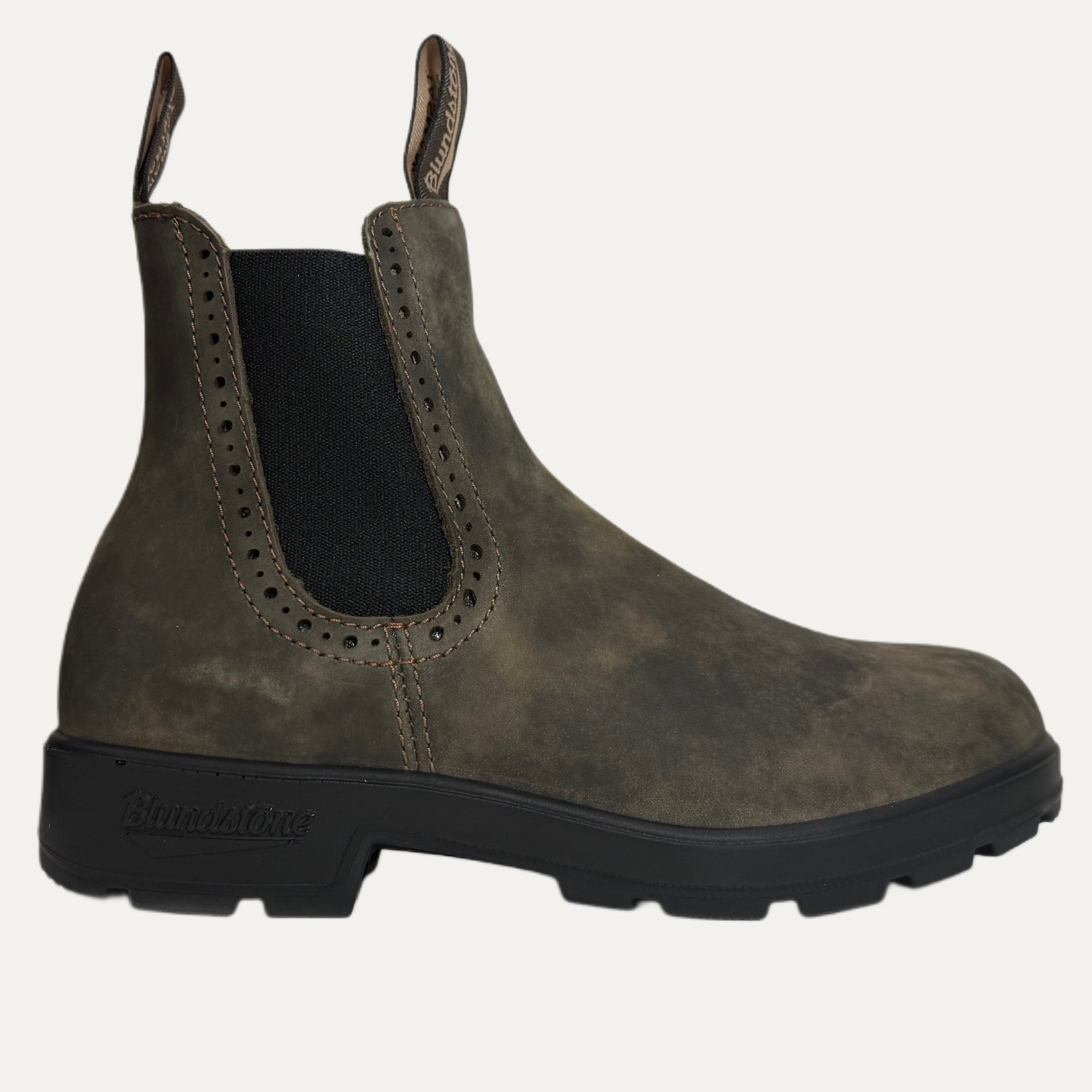 Brown Chelsea boot with black sole on a white background