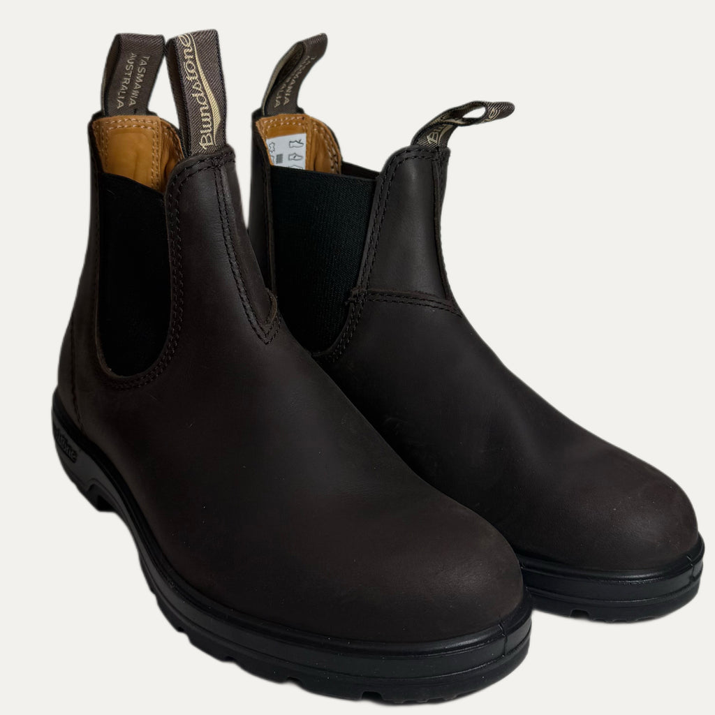 Pair of brown leather boots with black accents on a white background