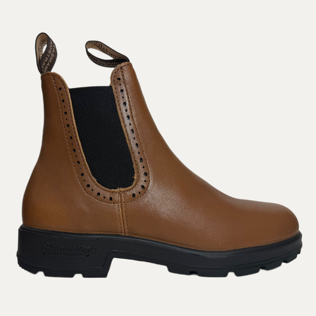 Brown Chelsea boot with black sole on a white background