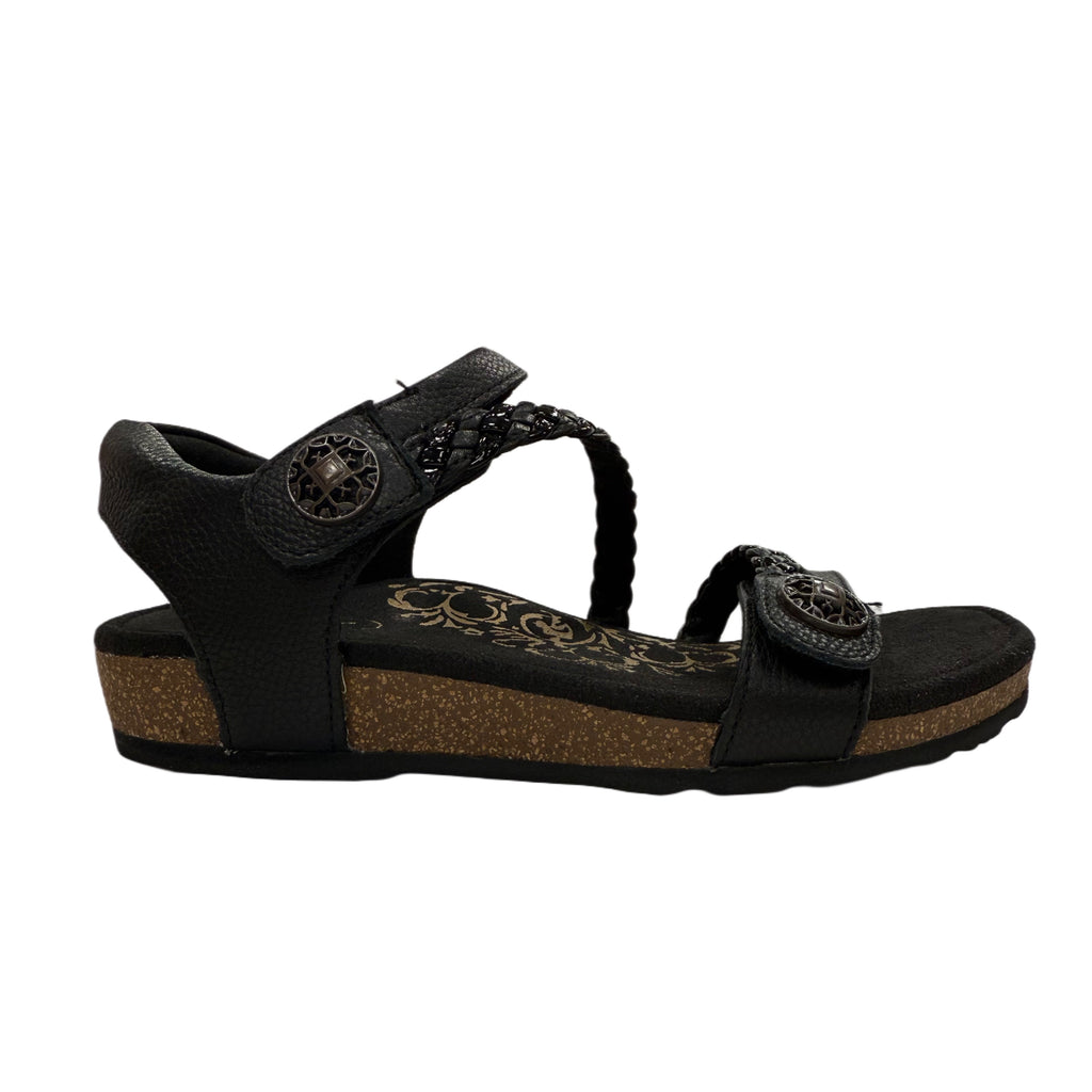 Black sandal with decorative straps on a white background
