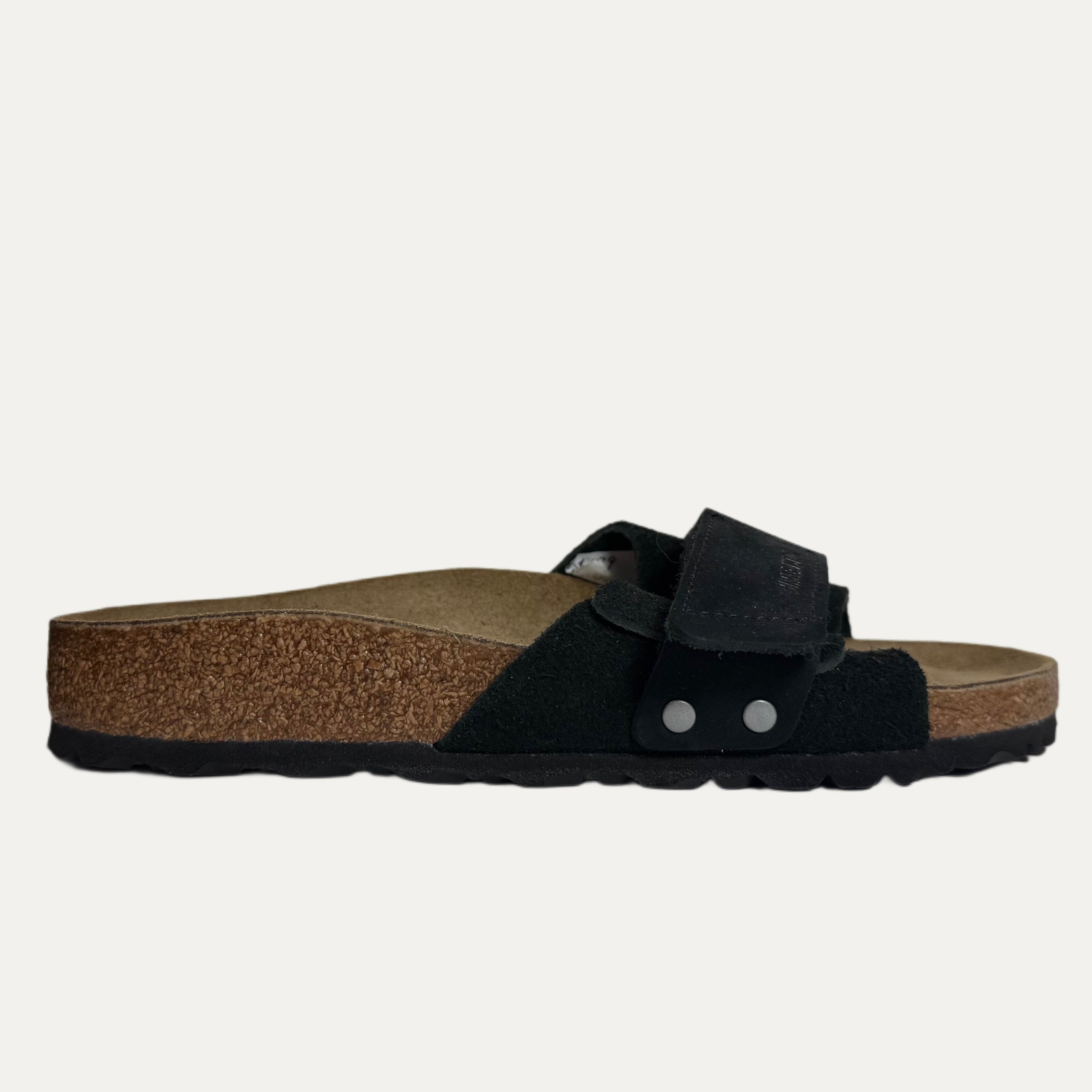 Black sandal with cork sole on a white background