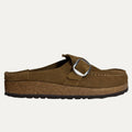 Brown clog shoe with a buckle on a white background