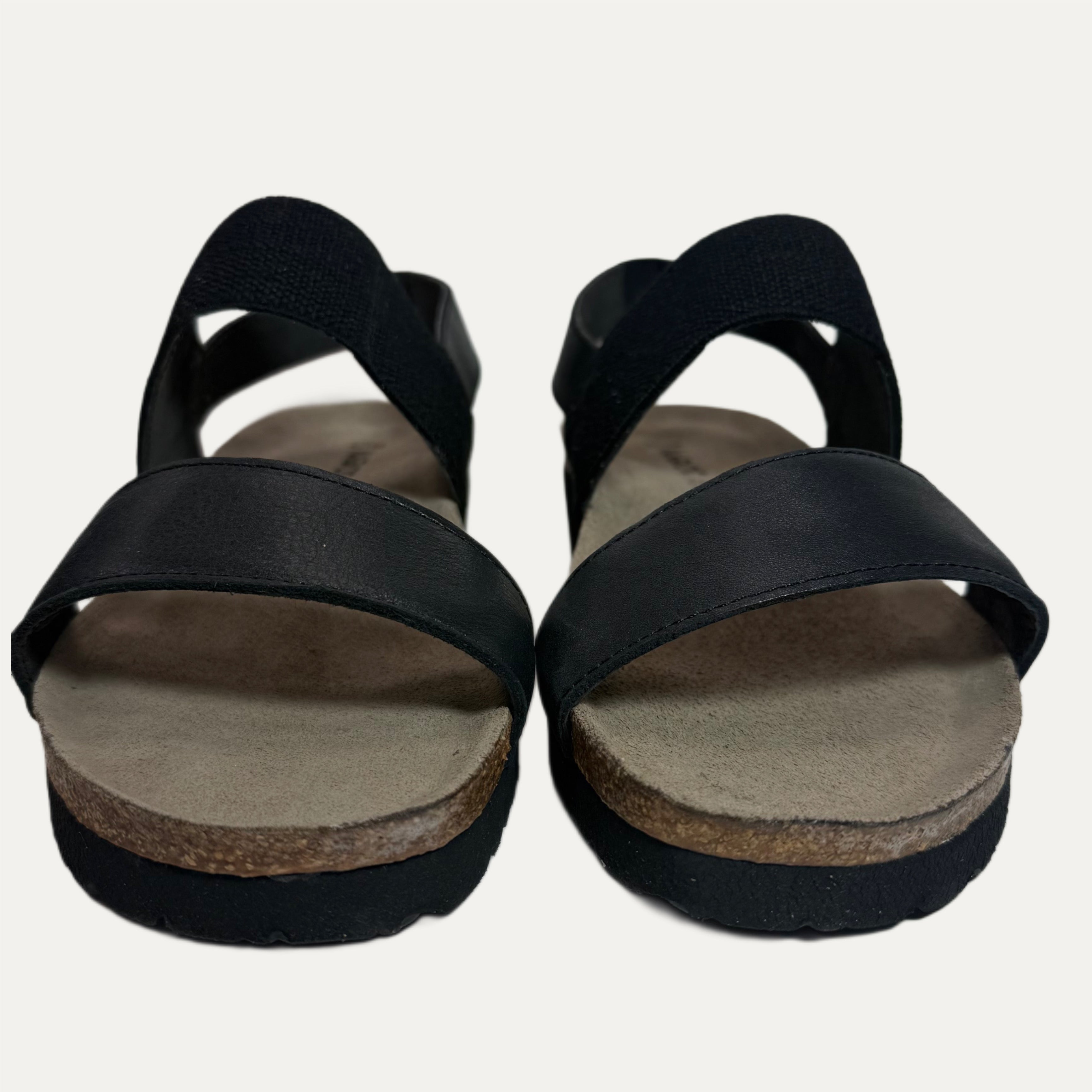 Black sandals with cork sole on a white background