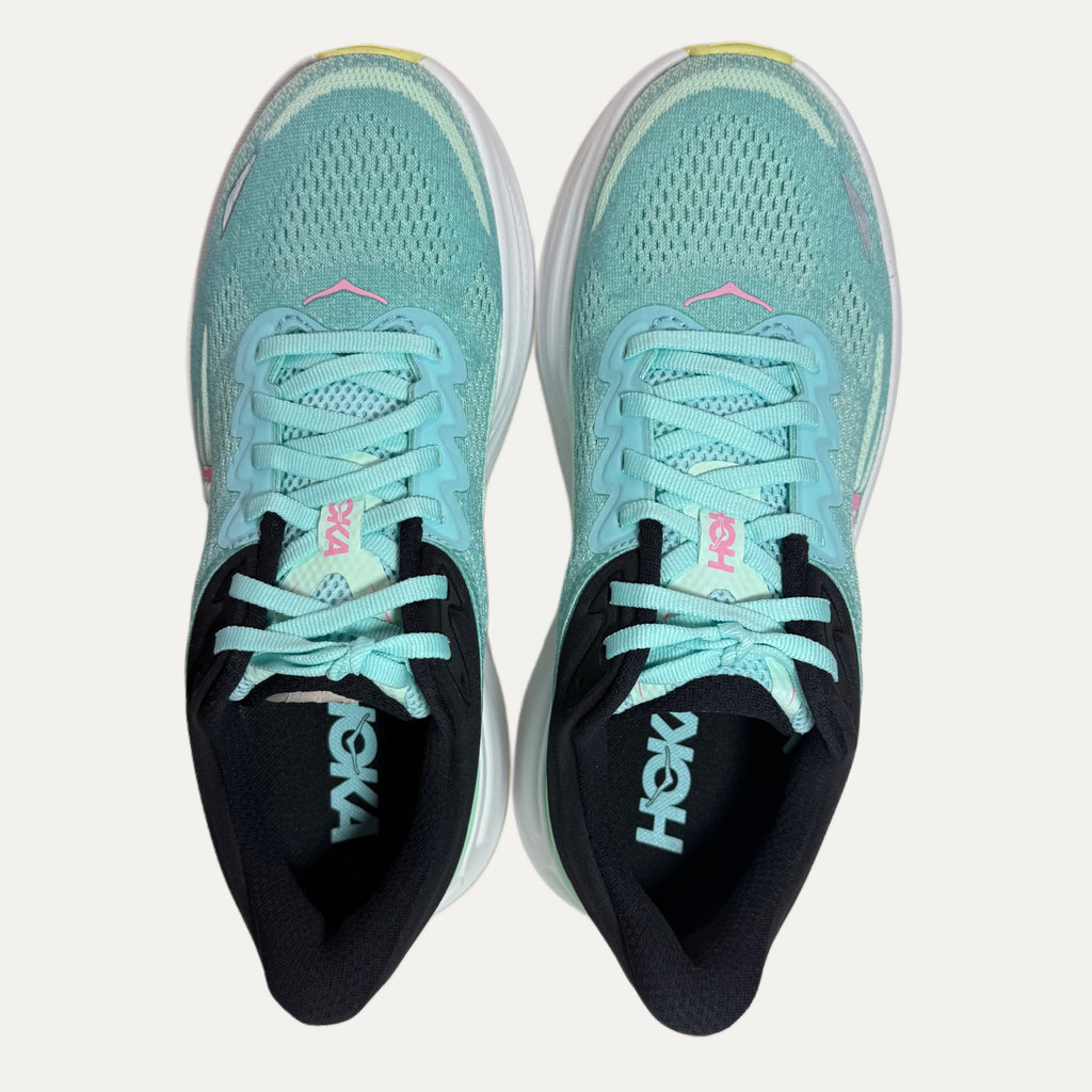 Pair of mint green hoka bondi 9 running shoes with black soles on a white background