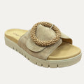 Beige sandal with bead embellishments on a white background