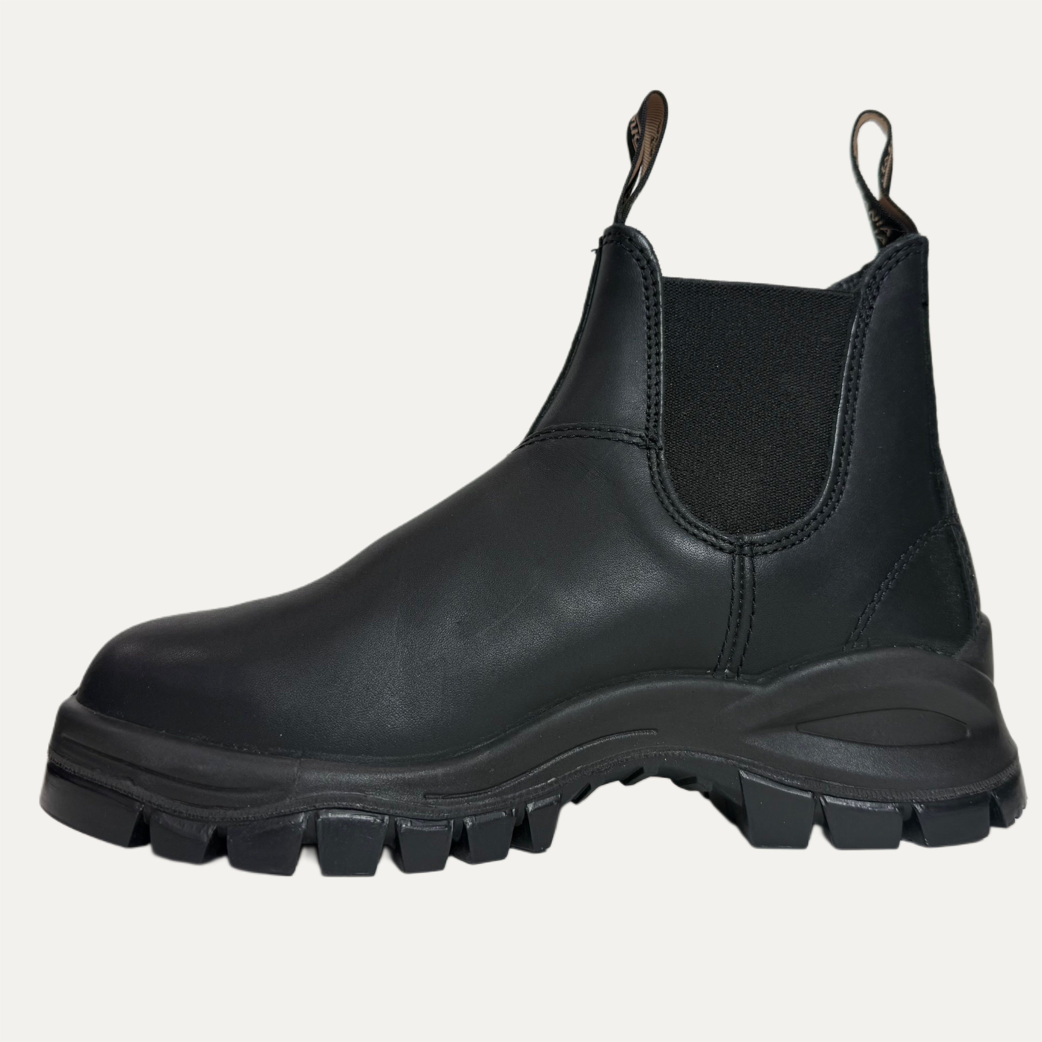 Black leather lugged boot with thick sole on a white background
