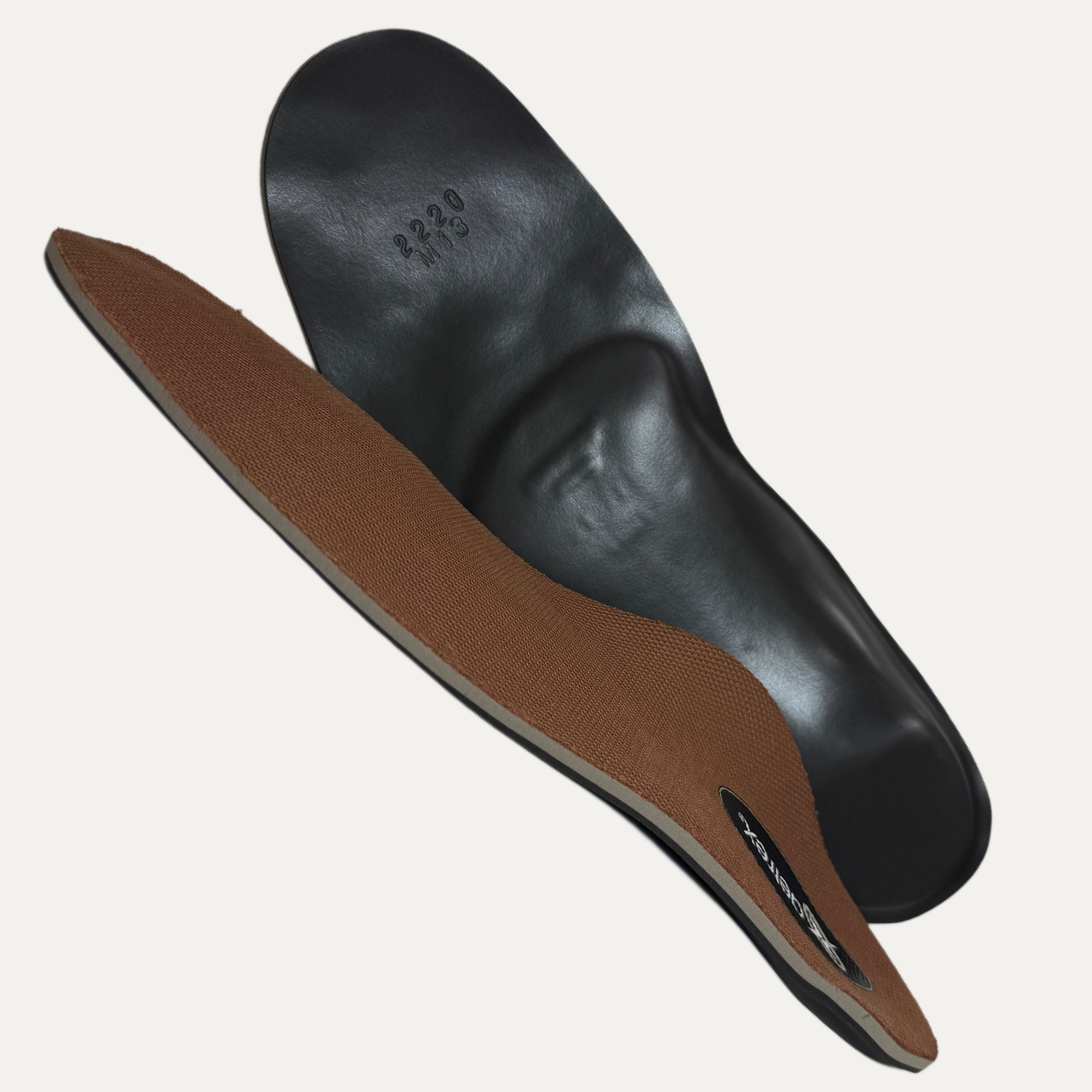 Brown shoe insole with black plastic shell on a white background