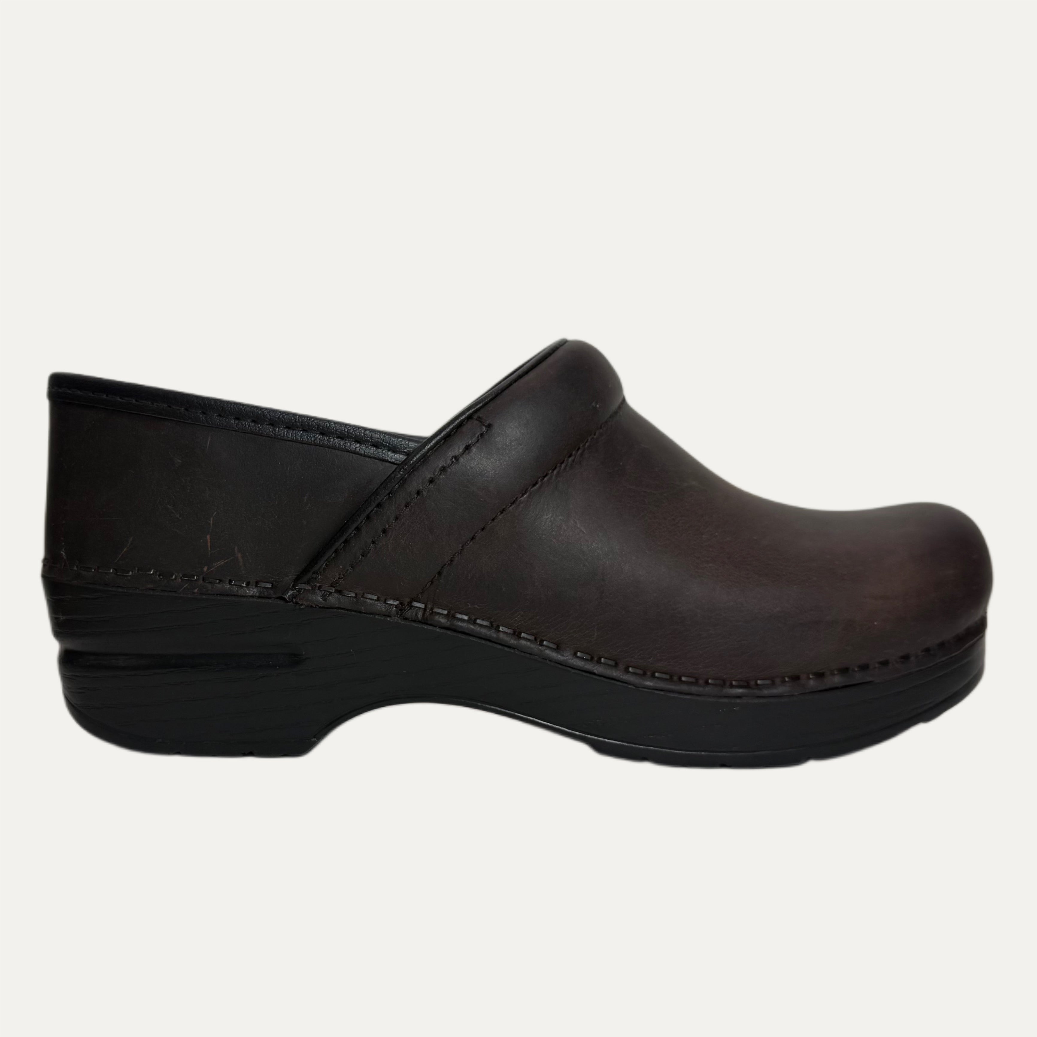 Black leather clog shoe on a white background