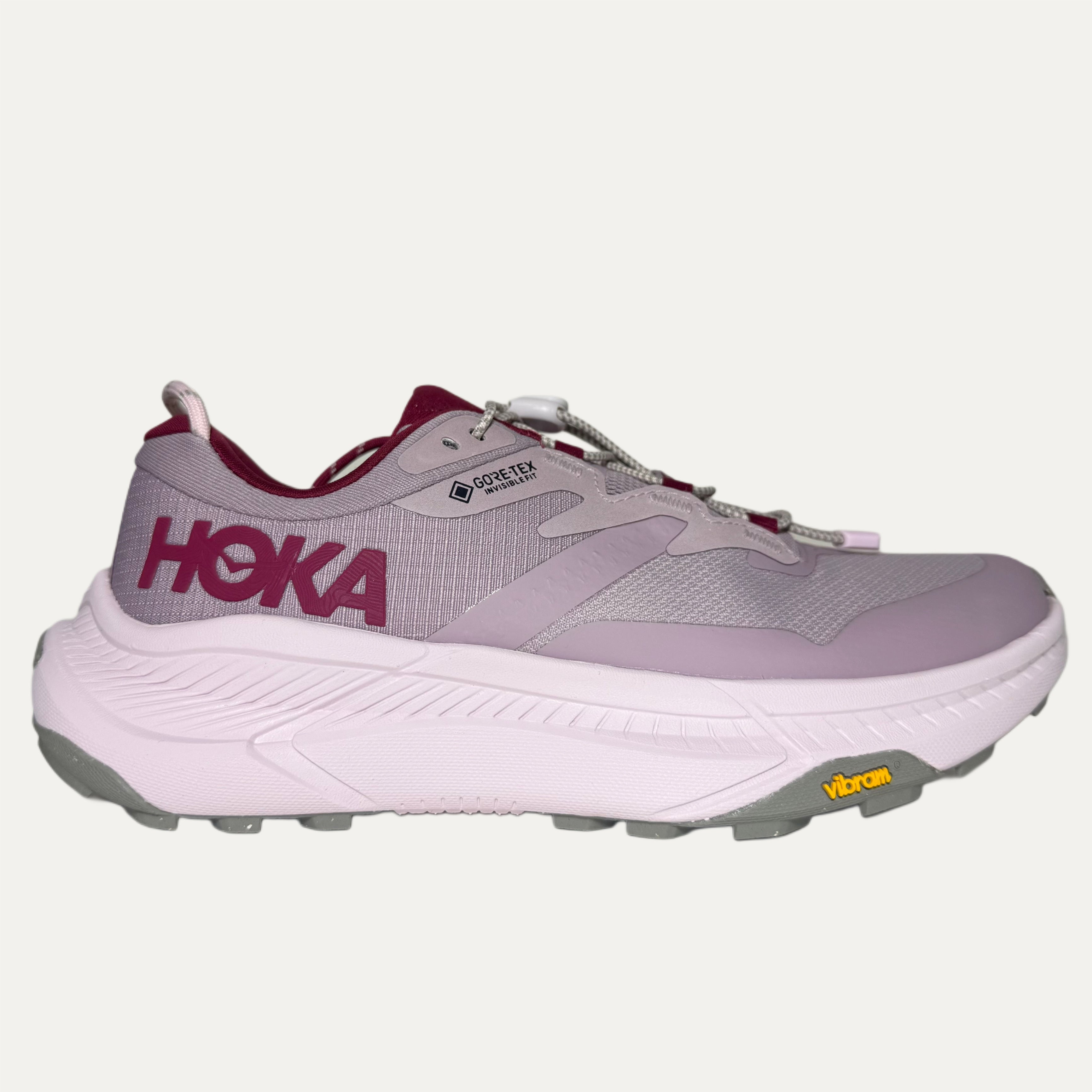 Lilac, red and pink athletic HOKA Tshoe on white background