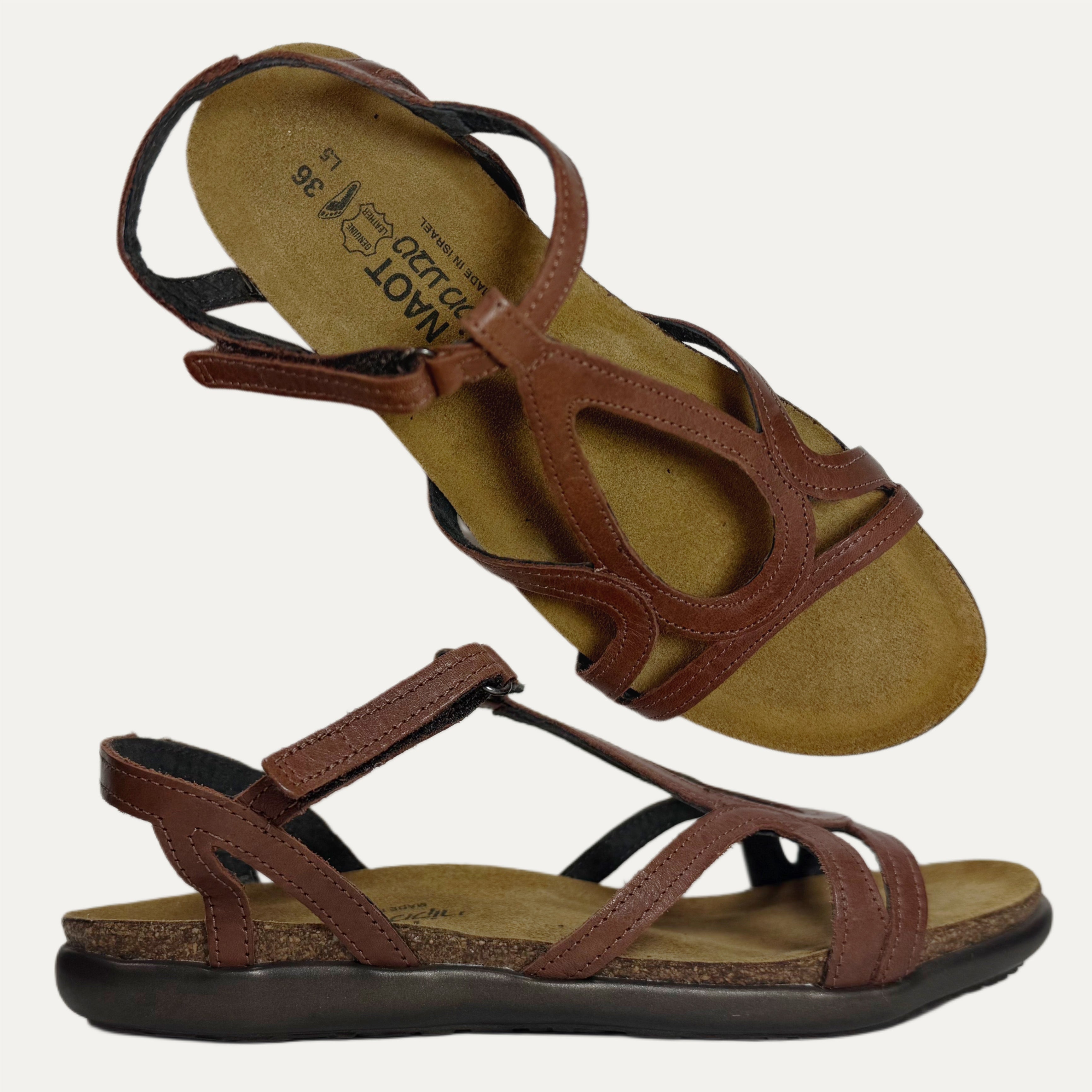 Brown sandals with multiple straps on a white background