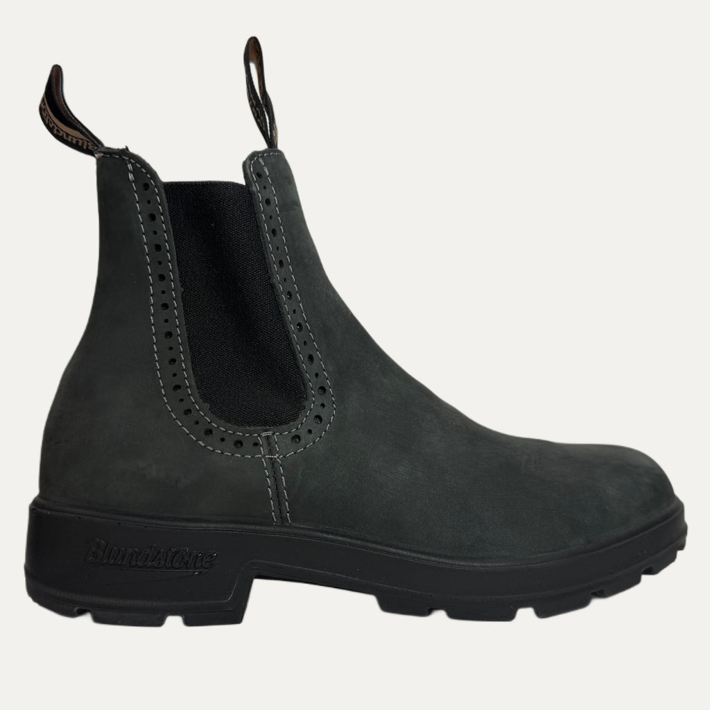Black Chelsea boot on a light gray background