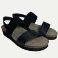 Black sandals with cork sole on a light gray background