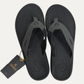 Gray flipflops with an Olukai tag on a white background