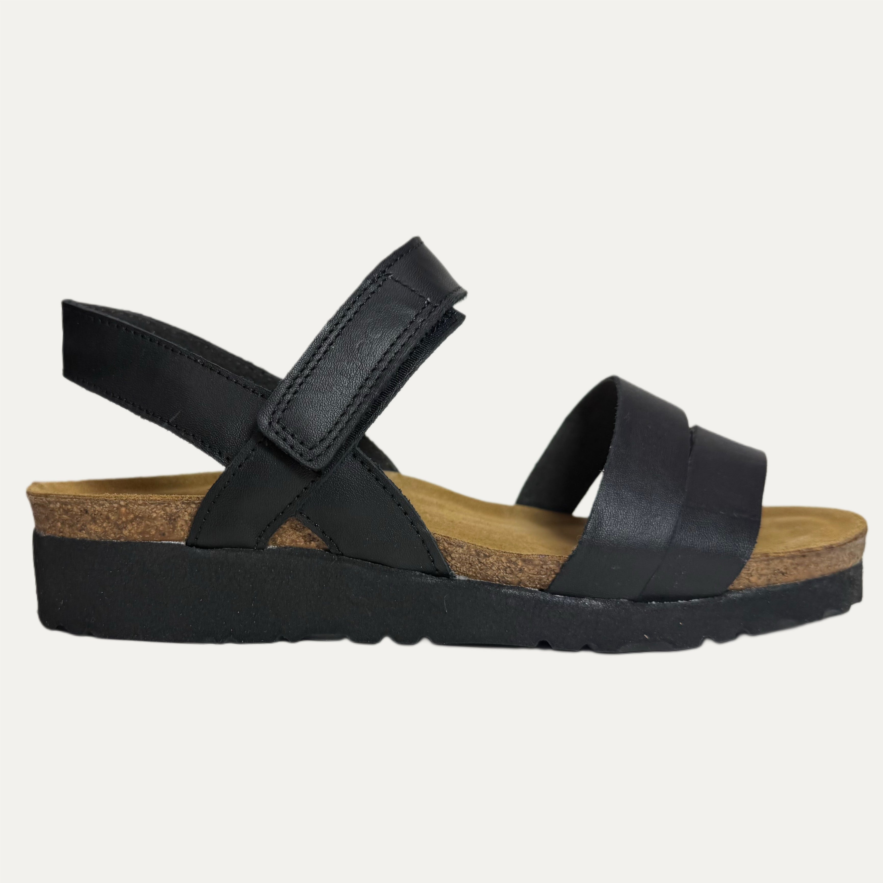 Black sandal with a cork sole on a white background