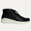 Black leather sneaker with white sole on a light gray background