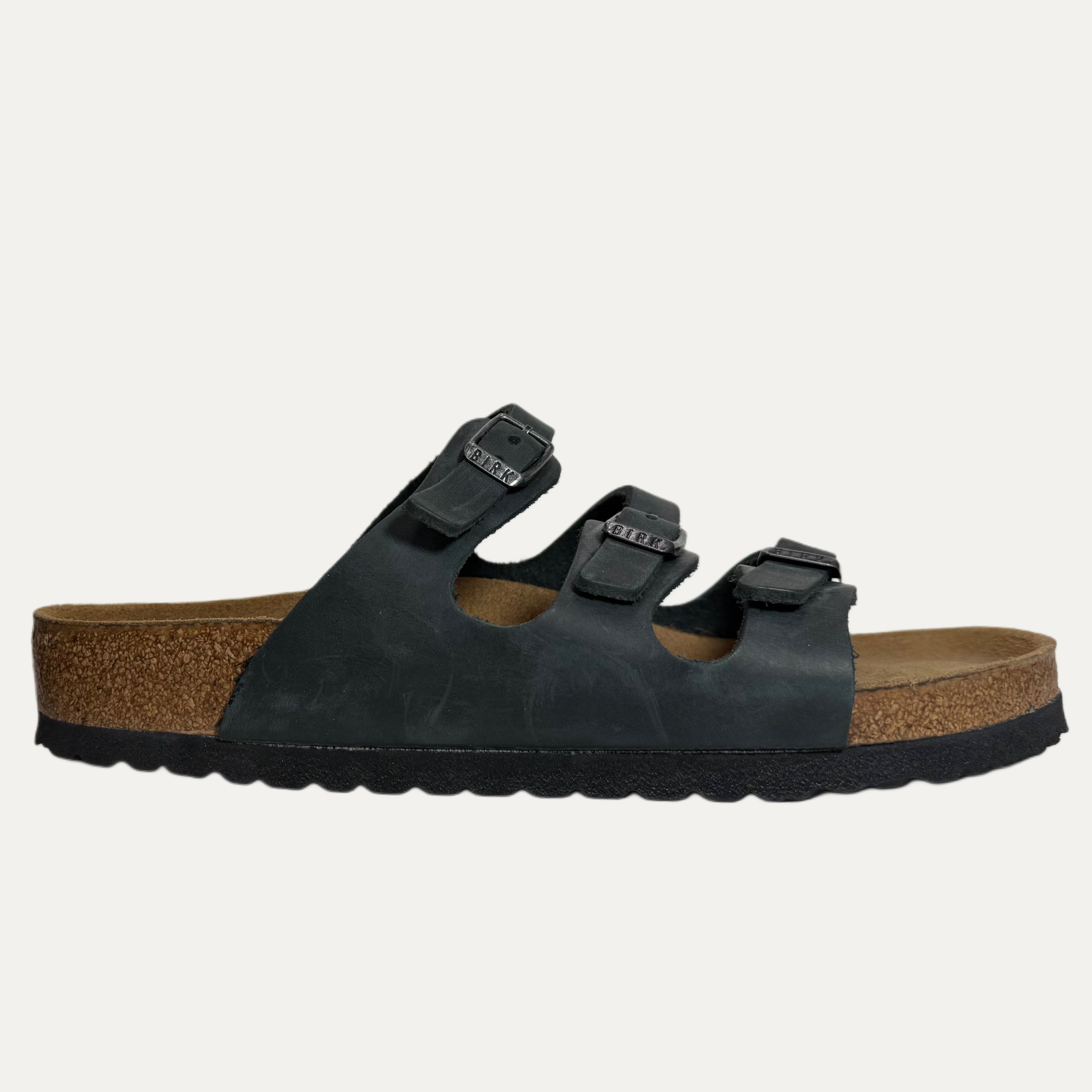 Black sandal with cork sole on a white background