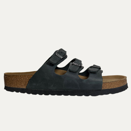 Black sandal with cork sole on a white background