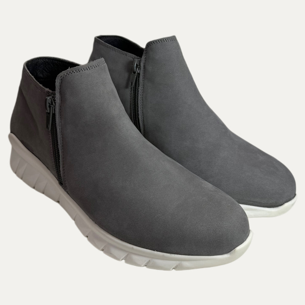 Pair of gray ankle boots with white soles on a white background