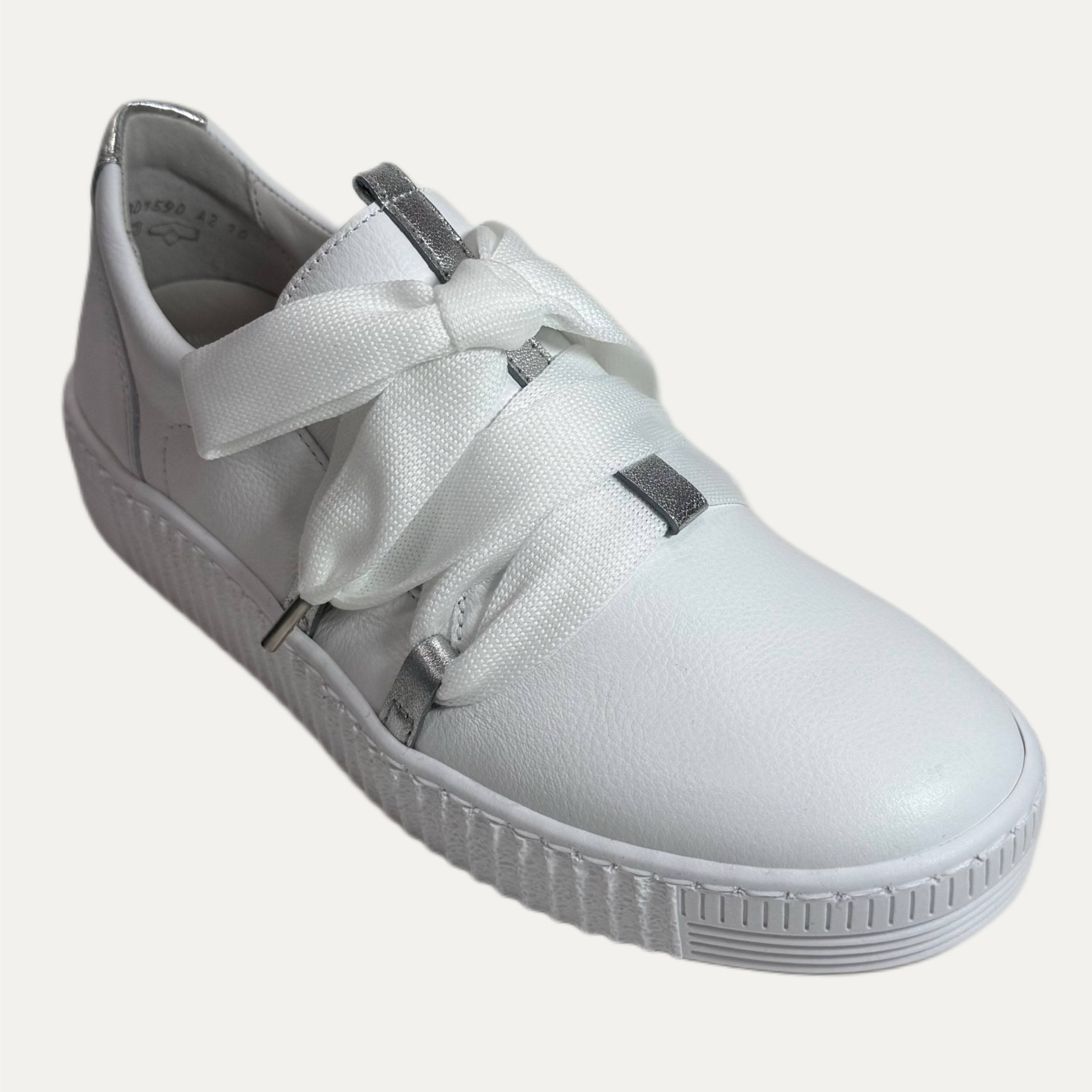 White sneaker with a bow lace on a white background