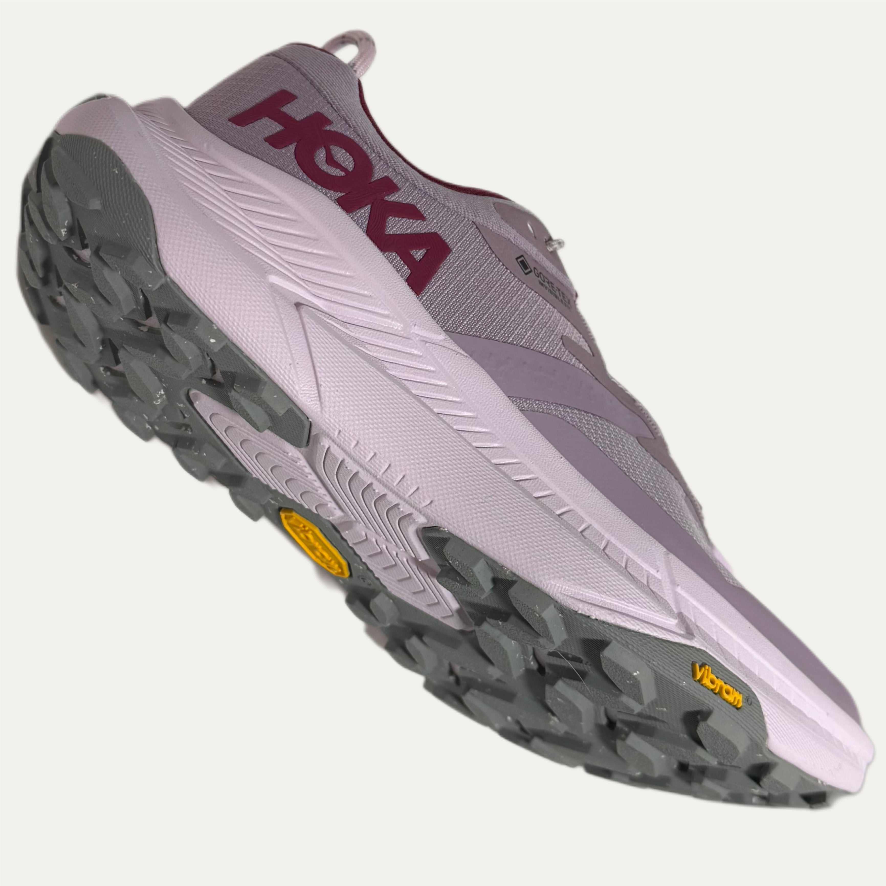 Lilac, red and pink athletic HOKA Transport shoe on white background