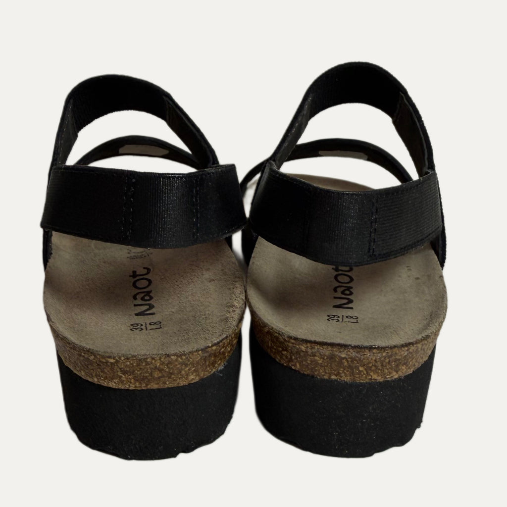 Black sandals with cork sole on a white background