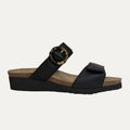 Black sandal with a cork sole on a light gray background