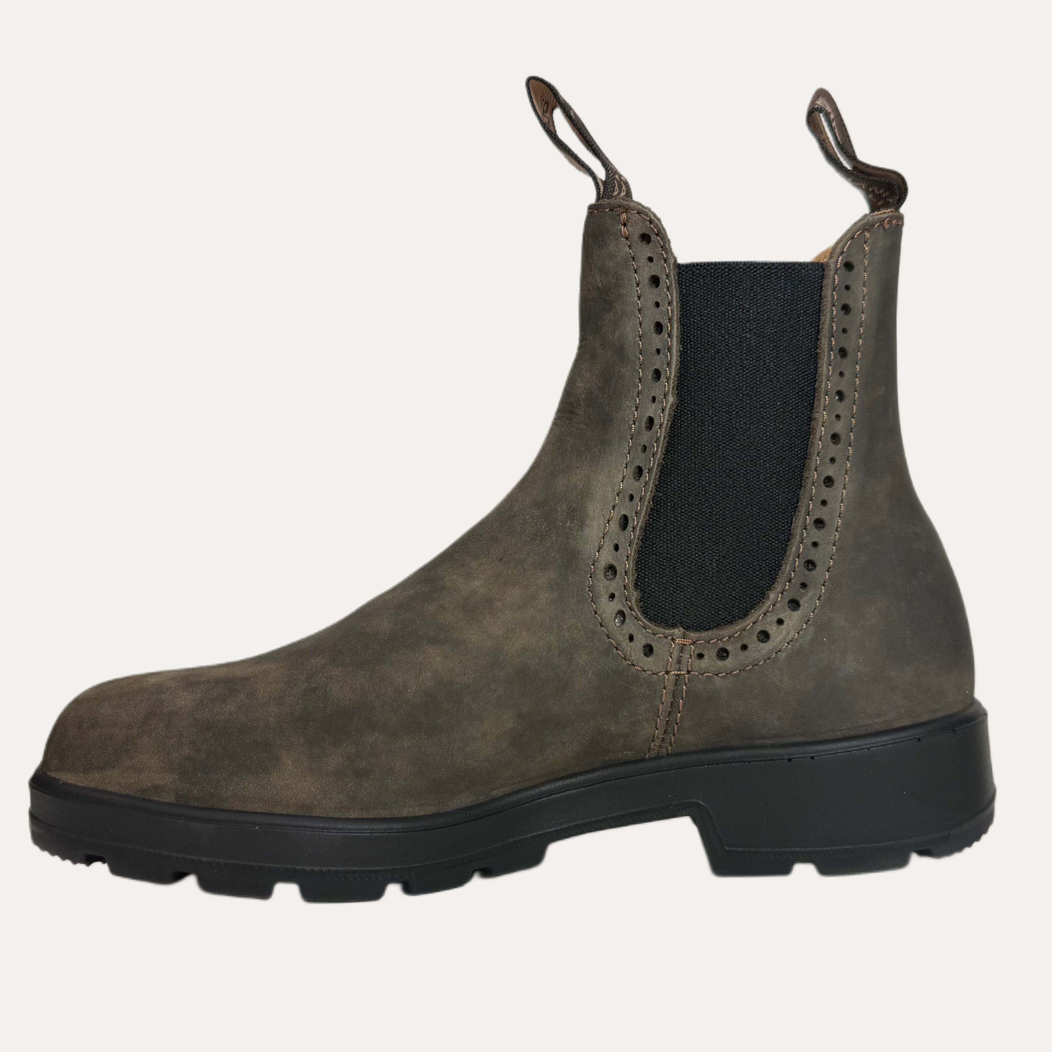 Brown Chelsea boot with black sole on a white background